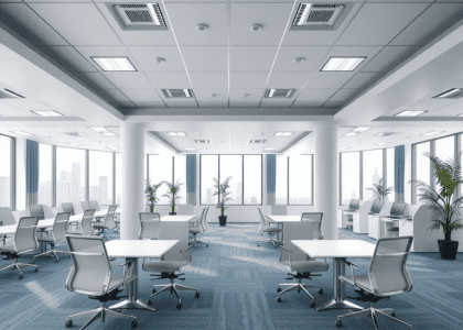 "Modern office workspace featuring stylish chairs, tables, and desks, with a green table lamp illuminating the area, embodying aesthetic office vibes and design studio inspiration."